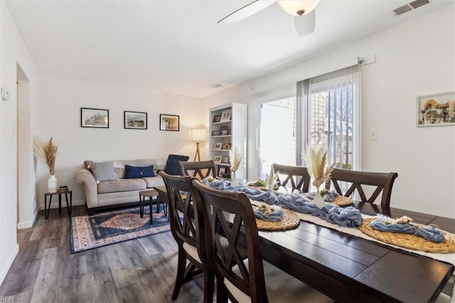 dining area with dark hardwood / wood-style floors and ceiling fan