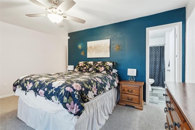 carpeted bedroom with ceiling fan and ensuite bath