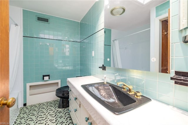 full bathroom with tile walls, shower / tub combo, vanity, decorative backsplash, and toilet