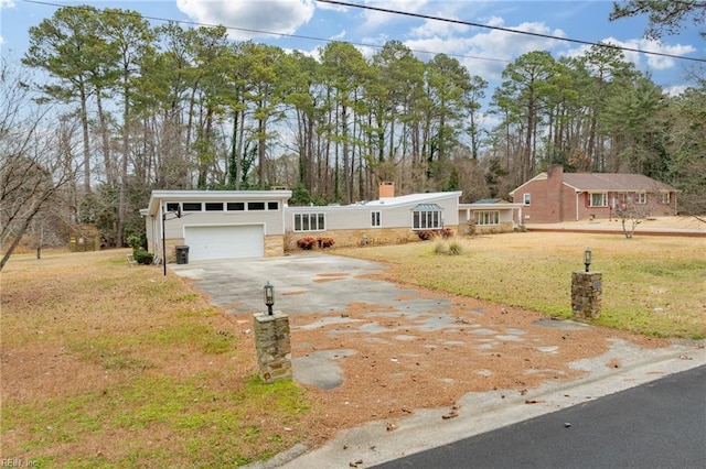 view of front of house featuring a garage and a front lawn