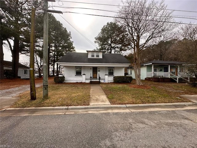 view of front of property with a porch and a front lawn