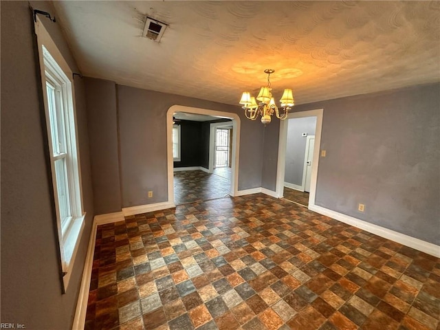 spare room with a chandelier