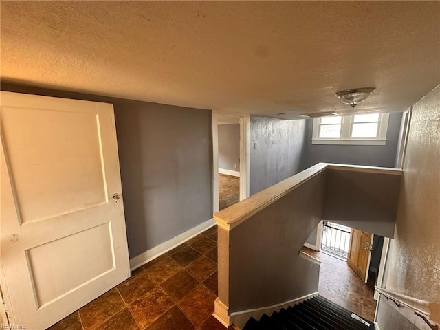 hallway with a textured ceiling