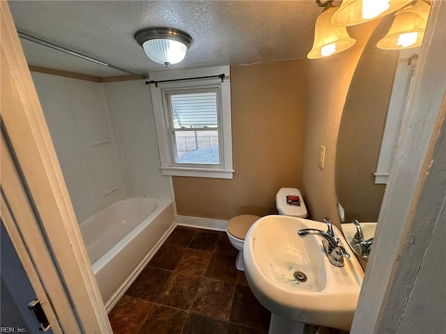 full bathroom with shower / washtub combination, sink, a textured ceiling, and toilet