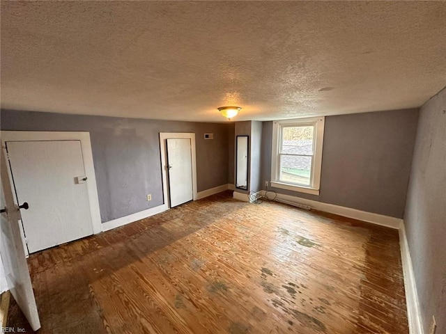 unfurnished bedroom featuring hardwood / wood-style flooring and a textured ceiling