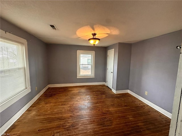 empty room with dark wood-type flooring