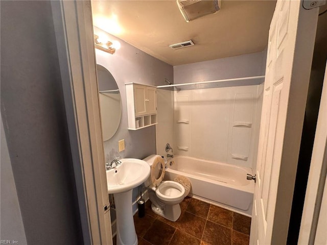 bathroom with washtub / shower combination and toilet