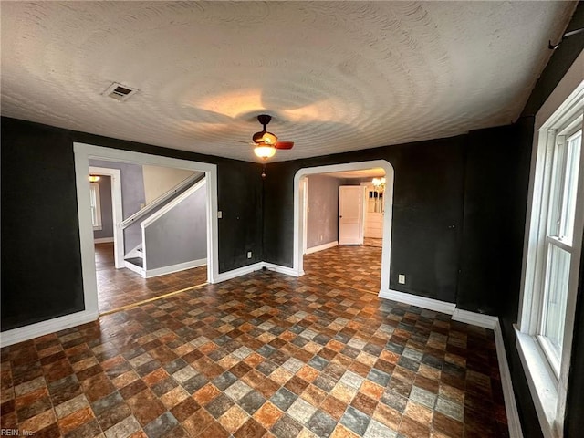 spare room featuring ceiling fan and a textured ceiling