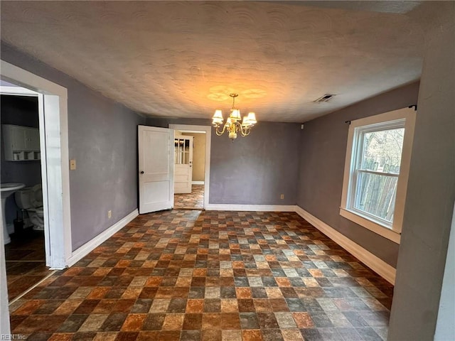 unfurnished dining area featuring a chandelier