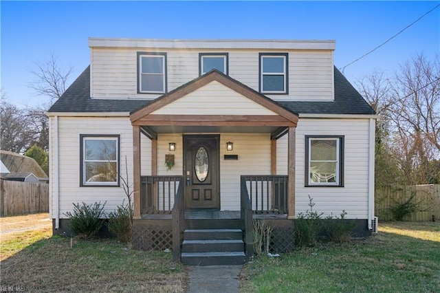 view of front of house with a front yard and covered porch