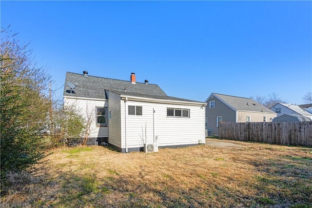 rear view of property with a lawn