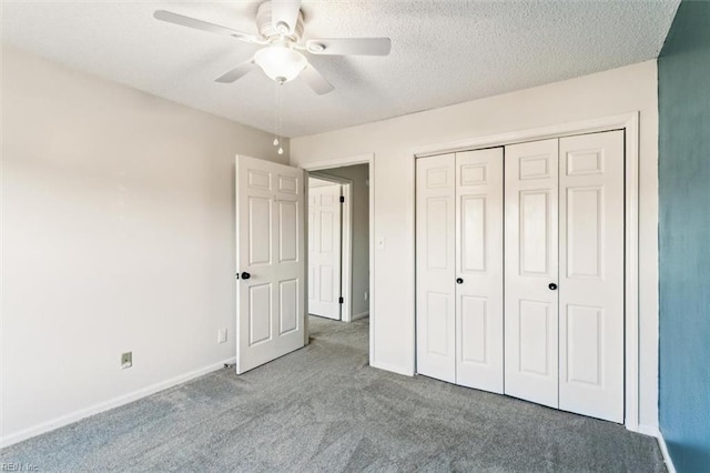 unfurnished bedroom featuring ceiling fan, carpet flooring, a textured ceiling, and a closet