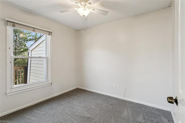 carpeted spare room featuring a textured ceiling and ceiling fan