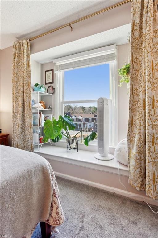 carpeted bedroom featuring a textured ceiling