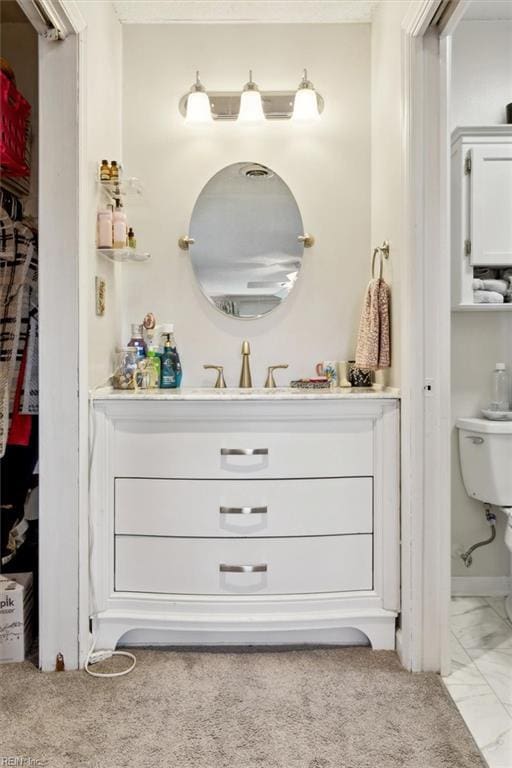 bathroom featuring vanity and toilet