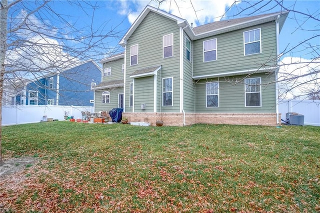 rear view of property with a yard and central air condition unit