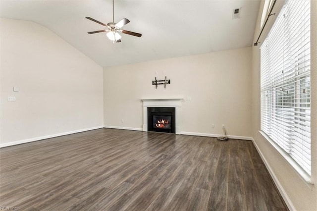 unfurnished living room with ceiling fan, dark hardwood / wood-style floors, and vaulted ceiling