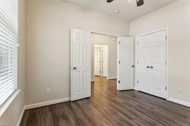 unfurnished bedroom with dark hardwood / wood-style floors, ceiling fan, and a closet