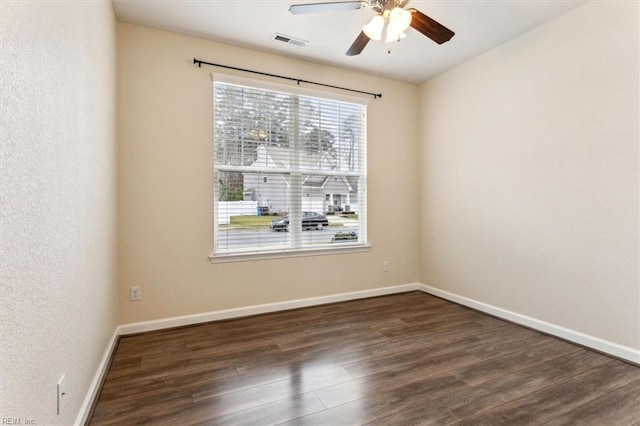 spare room with dark hardwood / wood-style floors and ceiling fan