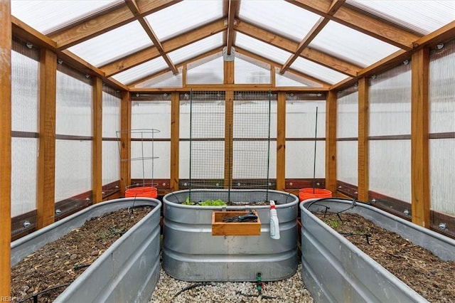 sunroom featuring lofted ceiling and a jacuzzi