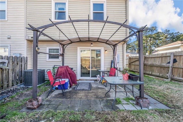 rear view of property featuring central AC unit and a patio