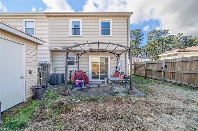 rear view of house with central AC unit, a pergola, and a patio