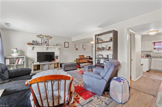 living room with a fireplace and light hardwood / wood-style flooring