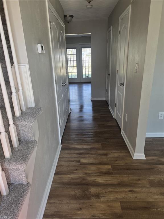 corridor with dark hardwood / wood-style flooring