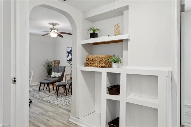 interior space featuring light hardwood / wood-style flooring, built in features, and ceiling fan