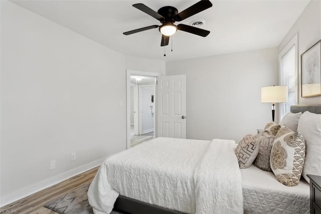 bedroom featuring hardwood / wood-style flooring and ceiling fan