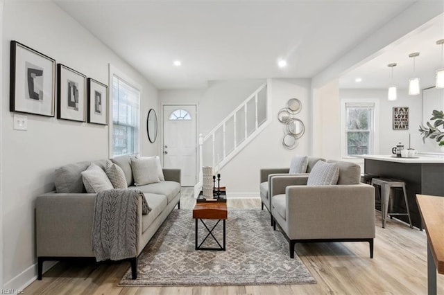 living room featuring a healthy amount of sunlight and light hardwood / wood-style floors