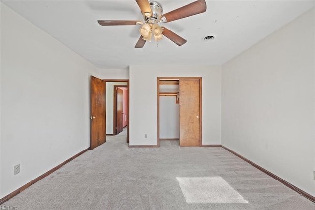 unfurnished bedroom with light carpet, a closet, and ceiling fan