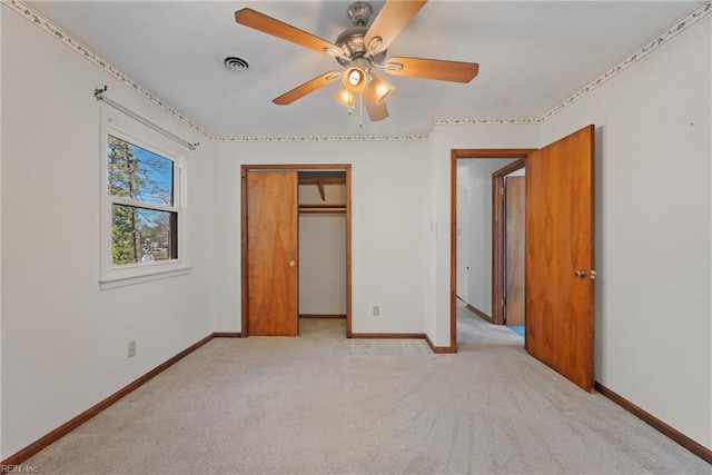 unfurnished bedroom with ceiling fan, a closet, and light carpet