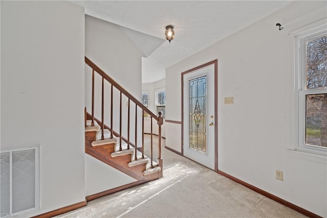 foyer entrance with light carpet