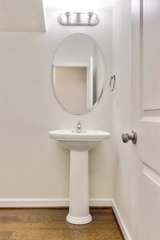 bathroom with hardwood / wood-style floors