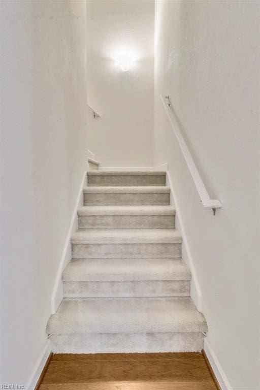 staircase featuring hardwood / wood-style flooring