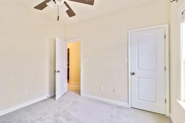 unfurnished bedroom with light carpet and ceiling fan