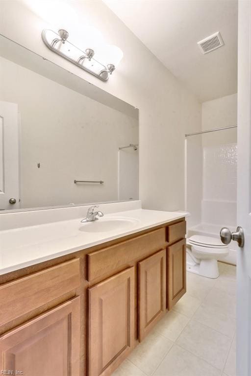 bathroom with tile patterned flooring, vanity, walk in shower, and toilet