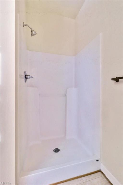 bathroom with a shower and tile patterned floors