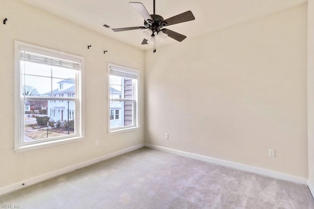 unfurnished room featuring light colored carpet and ceiling fan