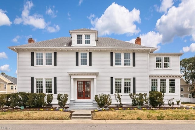 colonial home featuring french doors