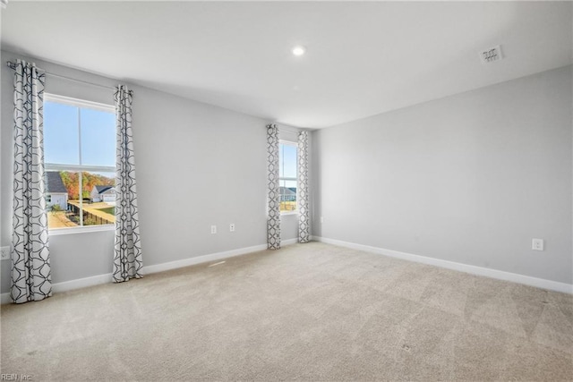 spare room with light colored carpet