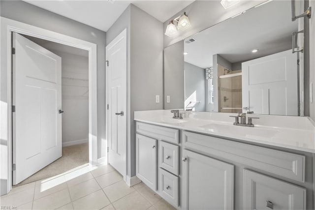 bathroom with vanity, an enclosed shower, and tile patterned flooring