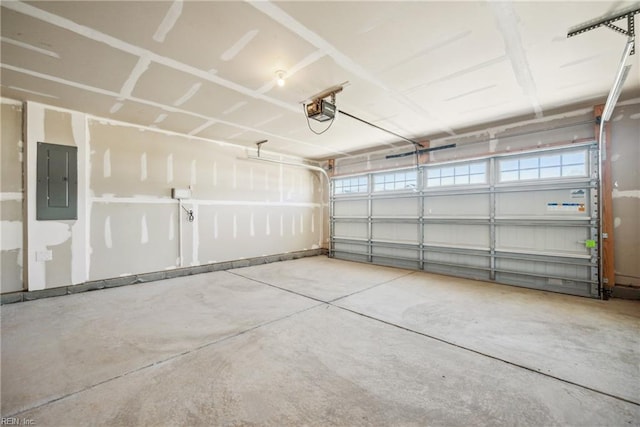 garage with a garage door opener and electric panel