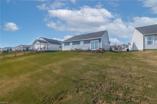 rear view of house with a yard