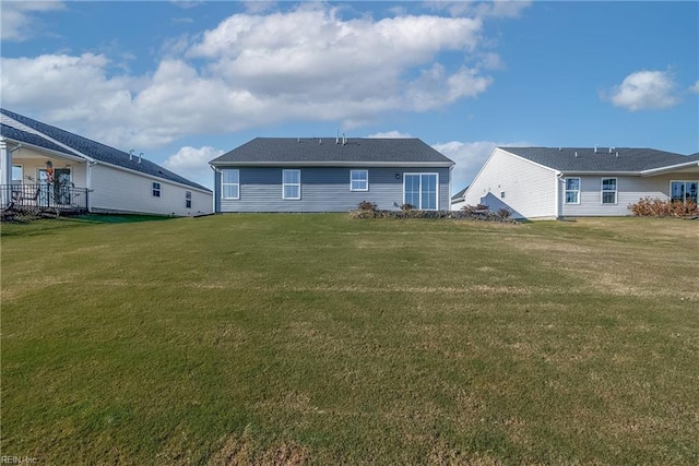 rear view of property with a yard