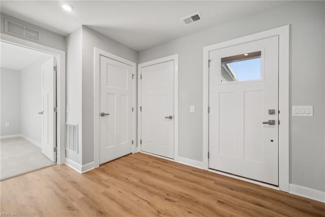 entryway with light hardwood / wood-style flooring