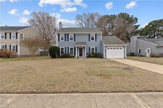 colonial home featuring a garage and a front lawn