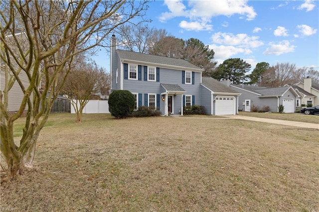 colonial home featuring a garage and a front lawn