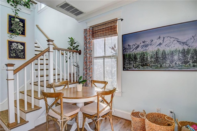 dining space with hardwood / wood-style flooring